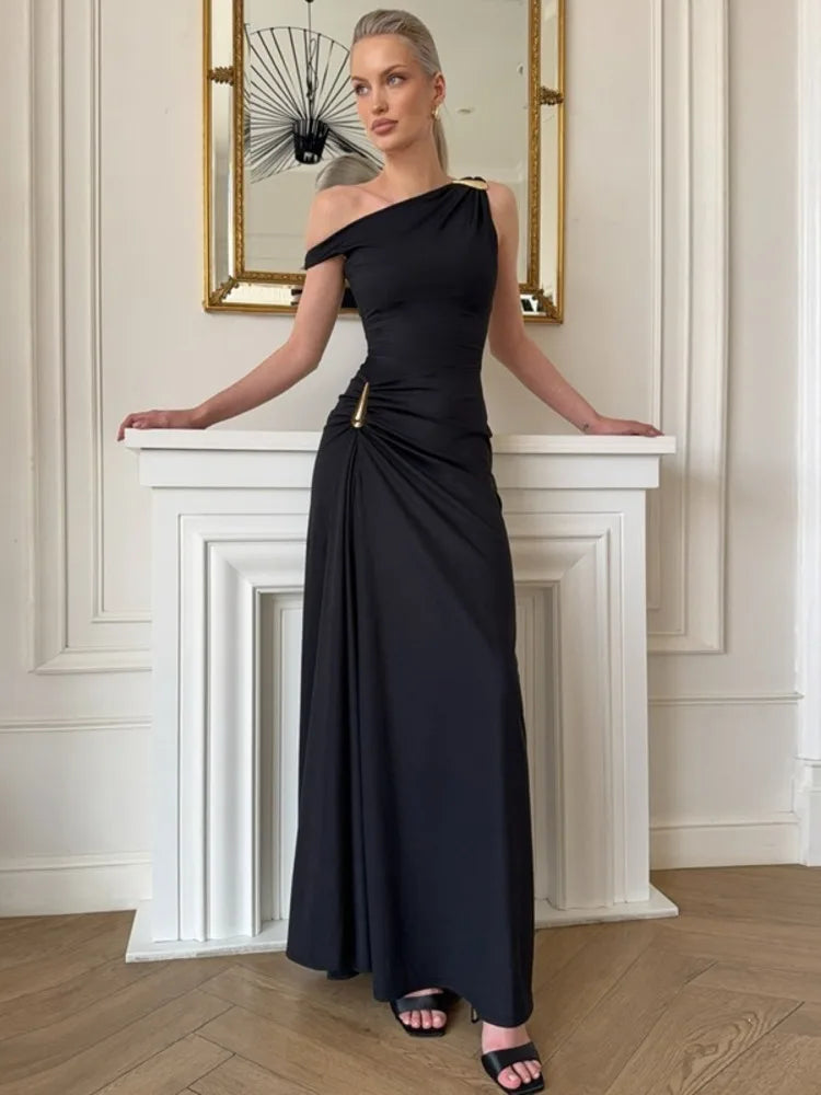 One shoulder high split ruched black maxi dress on fireplace