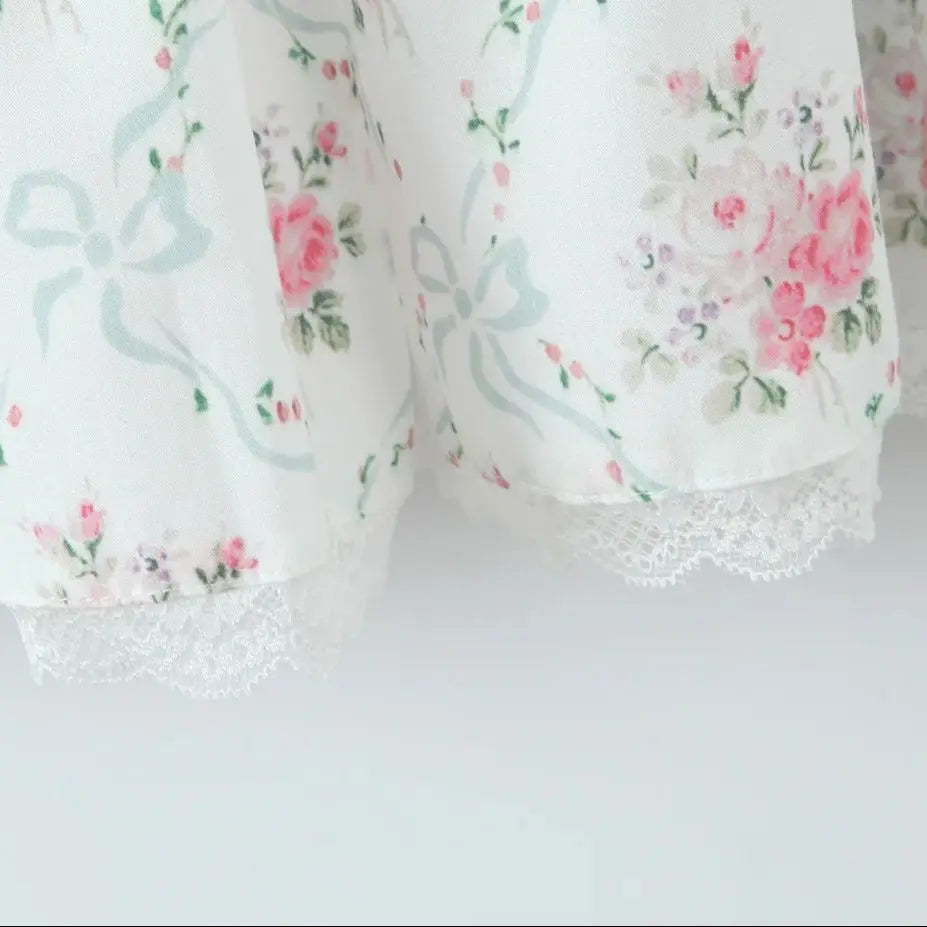 Floral-patterned fabric with lace trim on a white background