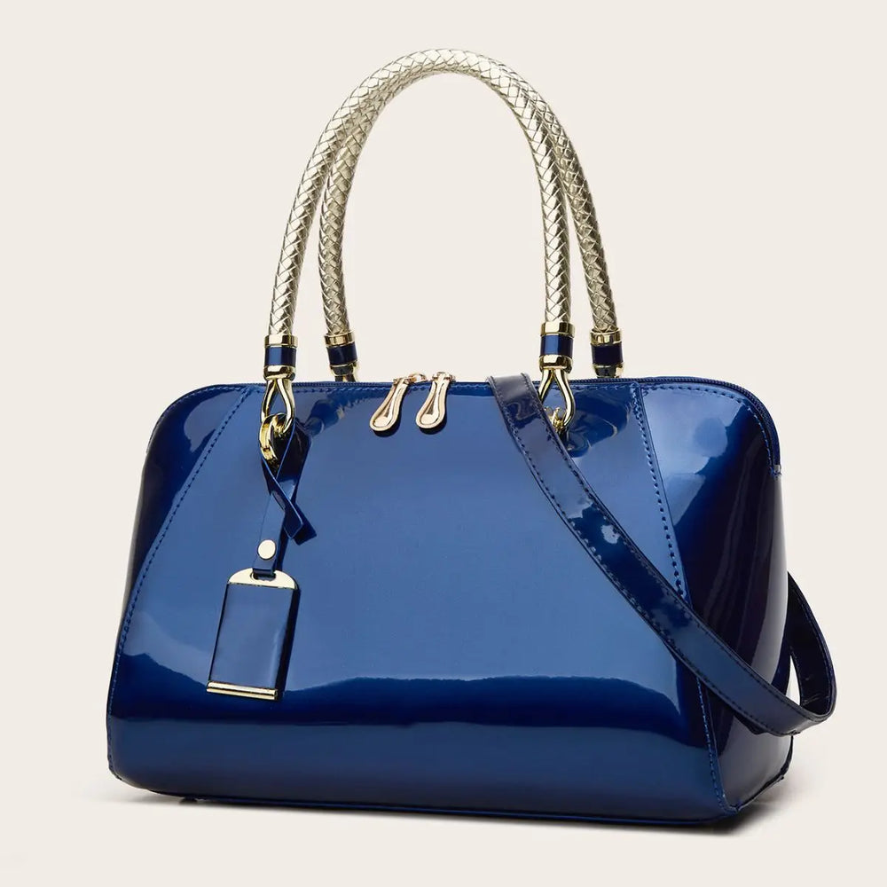 Blue patent leather Boston bag with braided handles and shoulder strap.