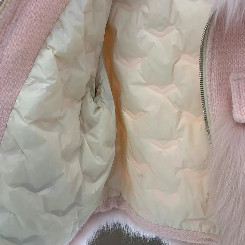 Close-up of a light pink puffer jacket with quilted design.