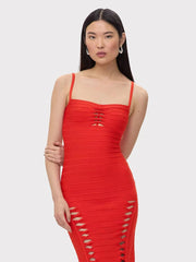 Woman wearing a red dress with cut-out details on a white background