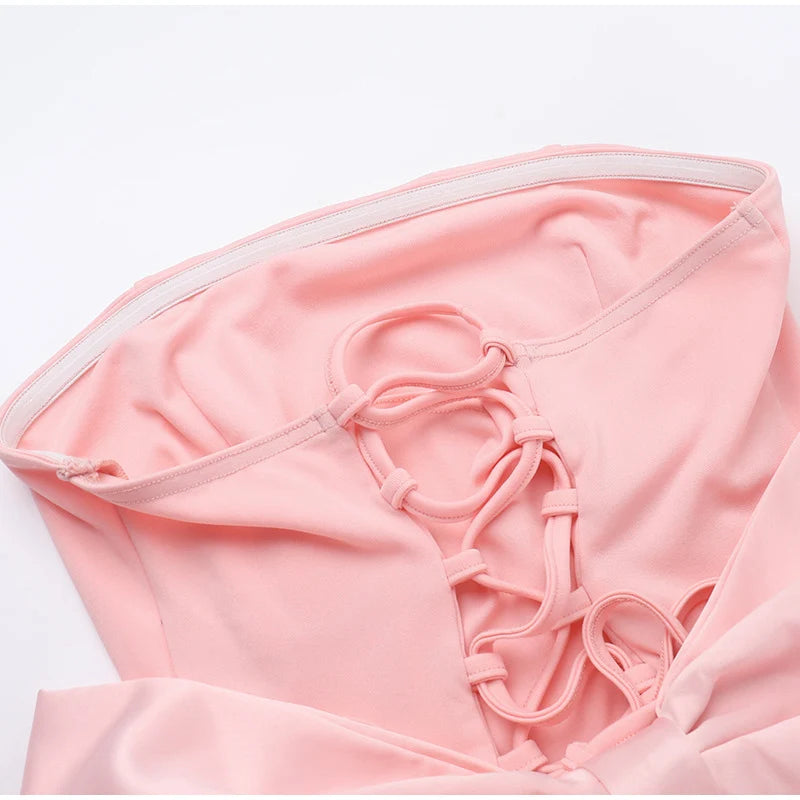 Pink bikini top with thin straps on a white background