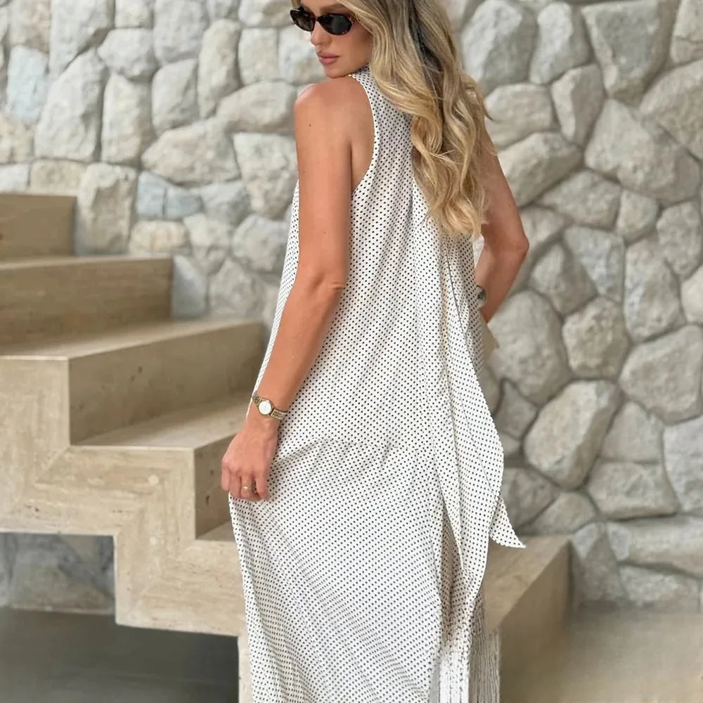 Woman wearing a sleeveless dress with a stone wall background