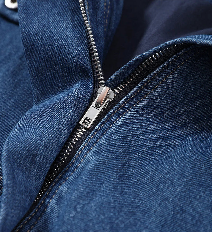 Close-up of a blue denim jacket with a zipper