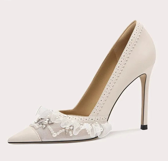 High-heeled shoe with lace details on a light gray background