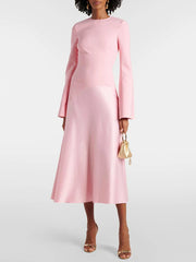 Pink long-sleeve O-neck midi dress showing the fitted bodice and flared skirt shape on model