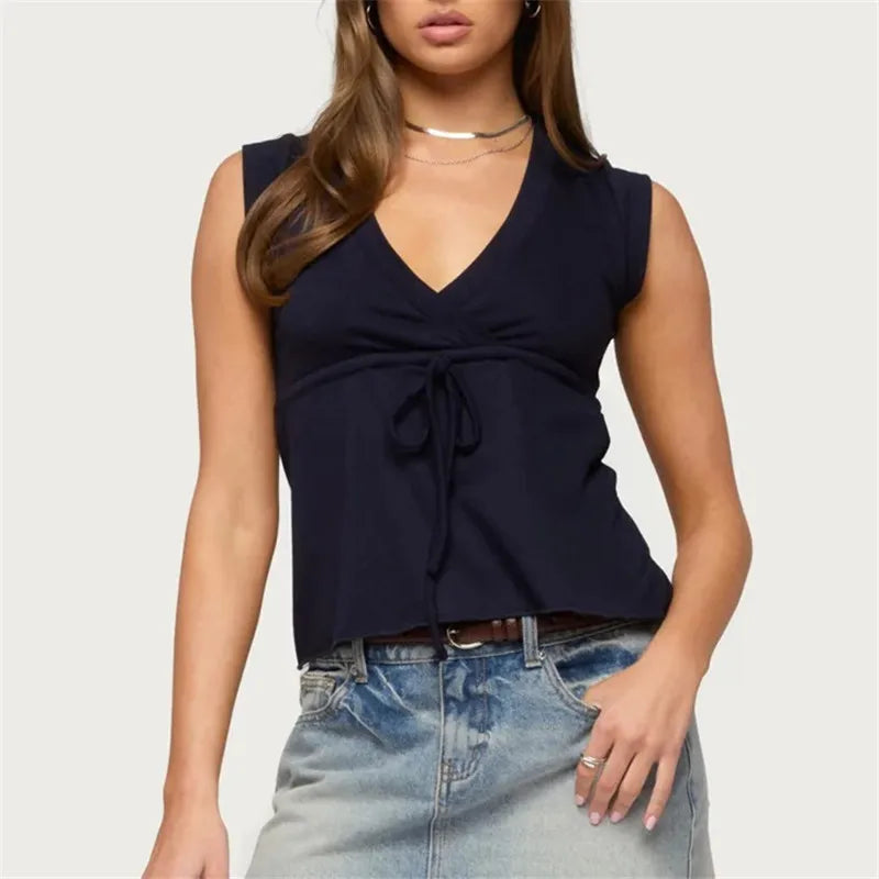 Sleeveless wrap front top with tie waist and peplum hem