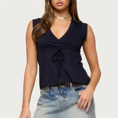 Sleeveless wrap front top with tie waist and peplum hem