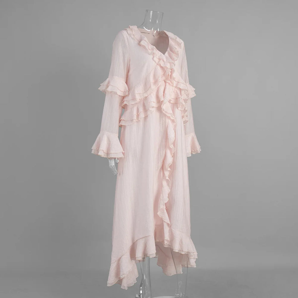 Pink ruffled dress on a mannequin against a gray background