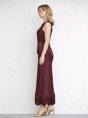 Side view of a burgundy sleeveless O-neck maxi dress with fringe trim.