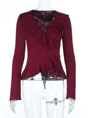 Red ruffled top on a mannequin against a white background