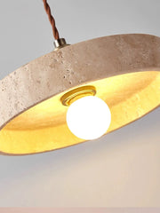  Close-up of the natural travertine stone texture and warm light emitted by the pendant light.  Golden Atelier 2