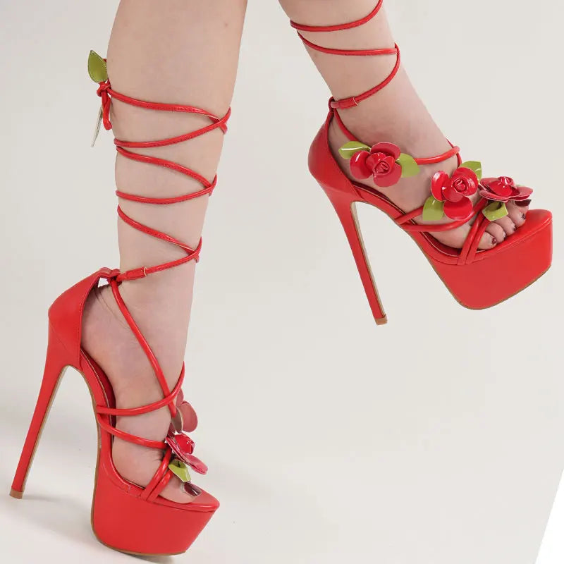 Red high-heeled shoes with floral decorations