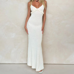 White evening gown with floral details on a plain background
