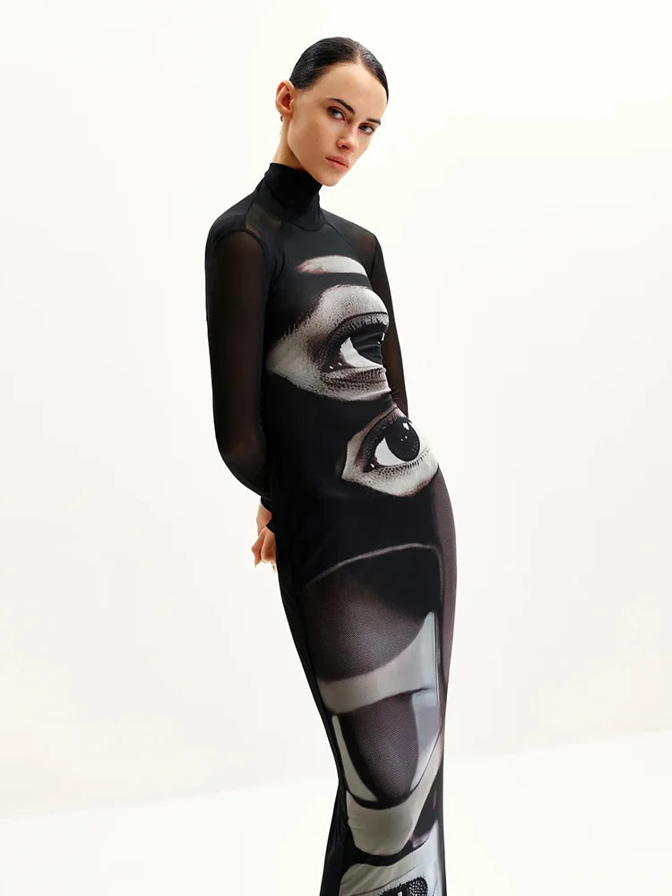 Woman wearing a black dress with a geometric pattern on a white background