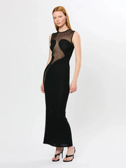 Woman wearing a black sleeveless dress with sheer panels on a white background