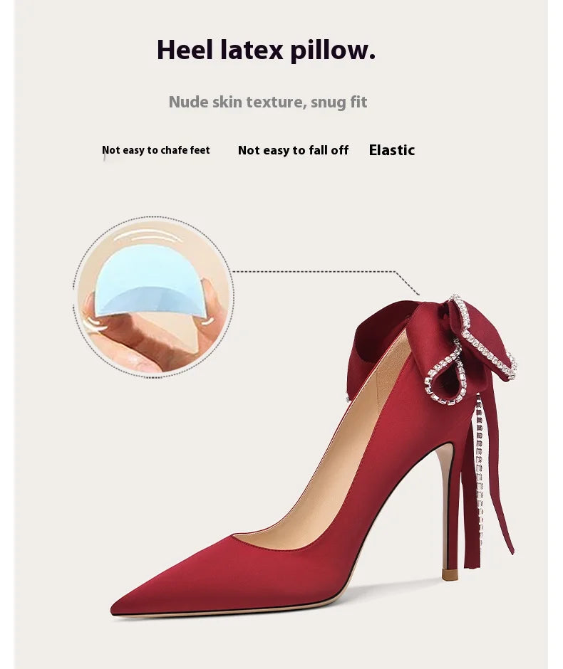 Red high-heeled shoe with a heel latex pillow feature on a light beige background