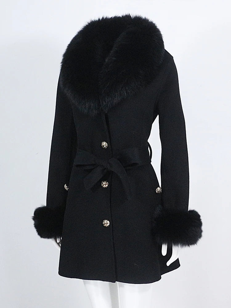 Black coat with fur trim on a white background