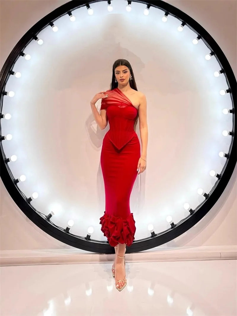 Red fitted gown with asymmetrical bodice and ruffled hem