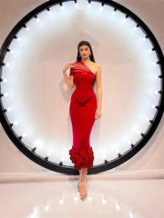 Red fitted gown with asymmetrical bodice and ruffled hem