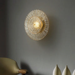 A sleek postmodern glass wall sconce illuminating a modern living room with soft, diffused light. D