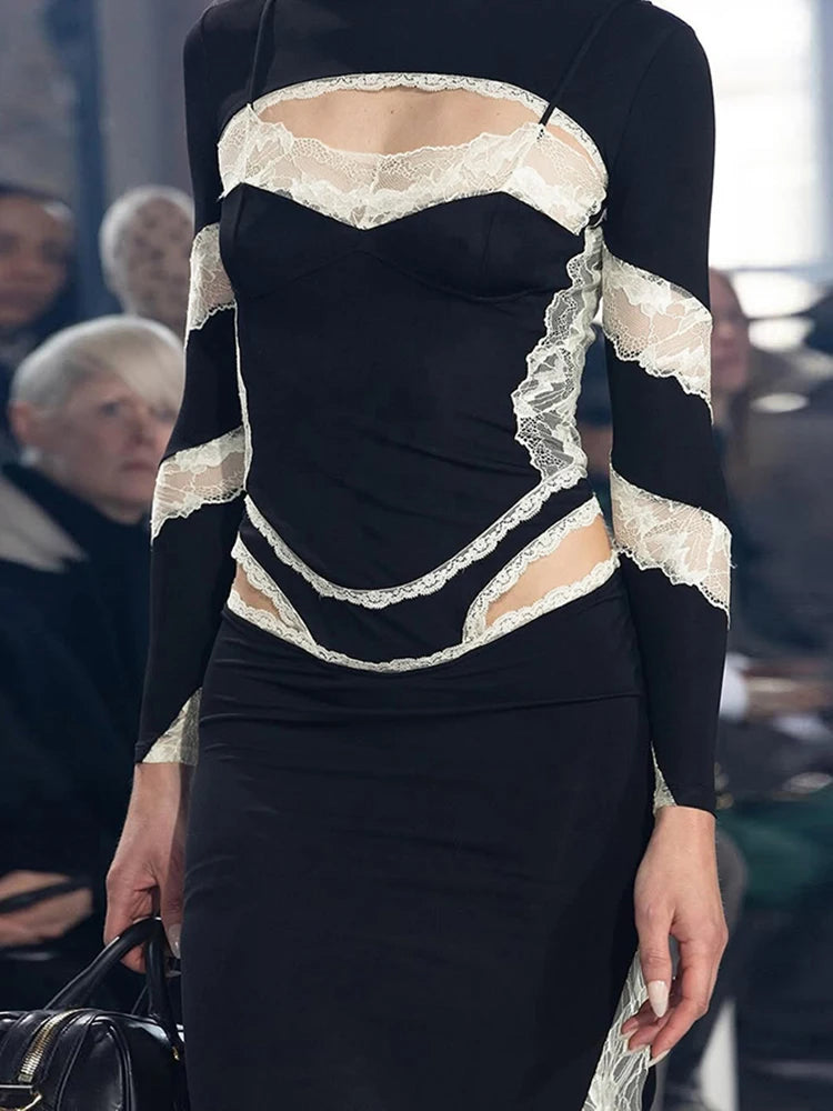 Black dress with lace detailing on a runway