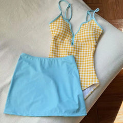 Yellow gingham print one-piece swimsuit with blue cover-up skirt