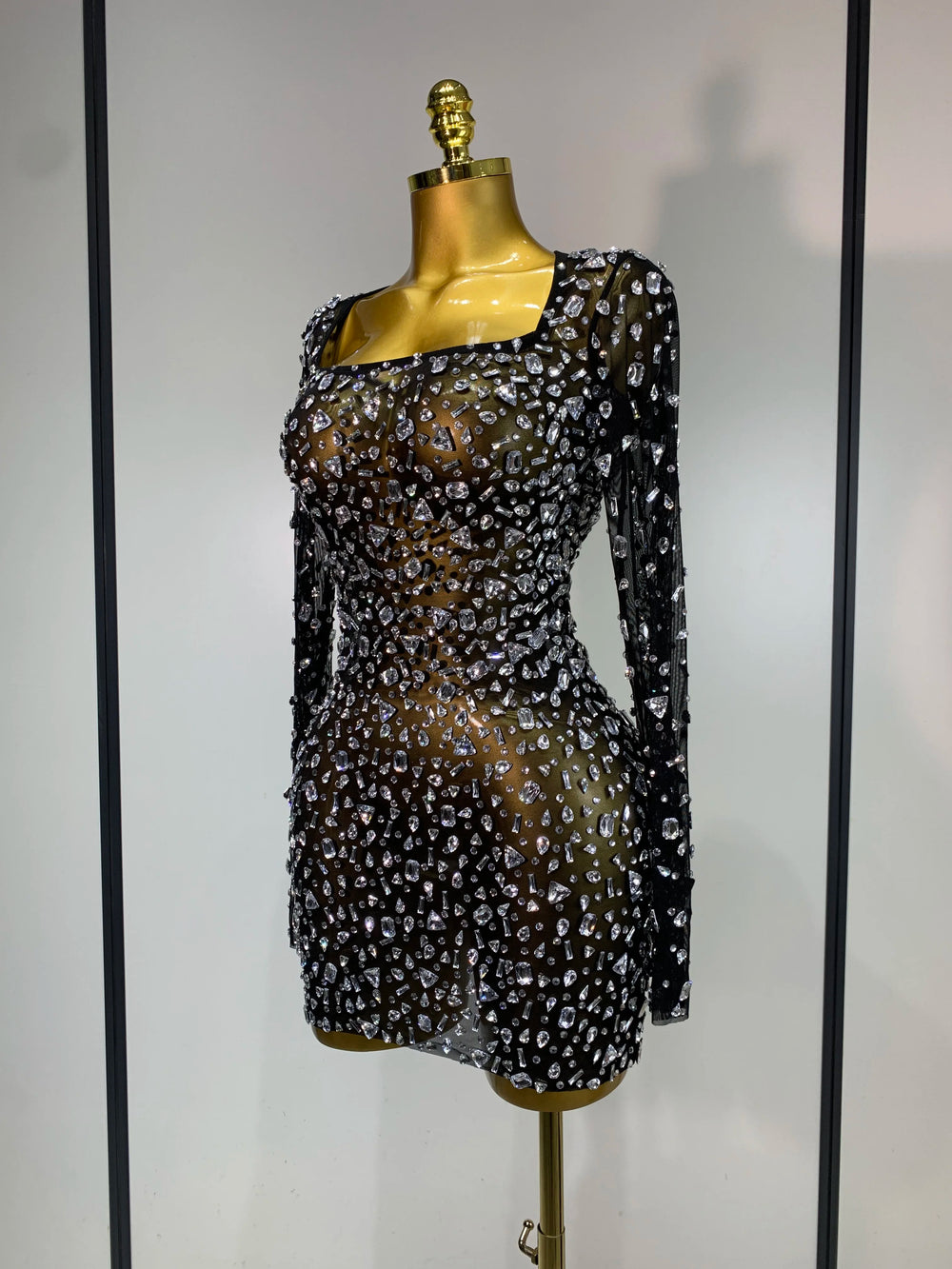 Close-up of black full sleeve crystal embellished mini dress