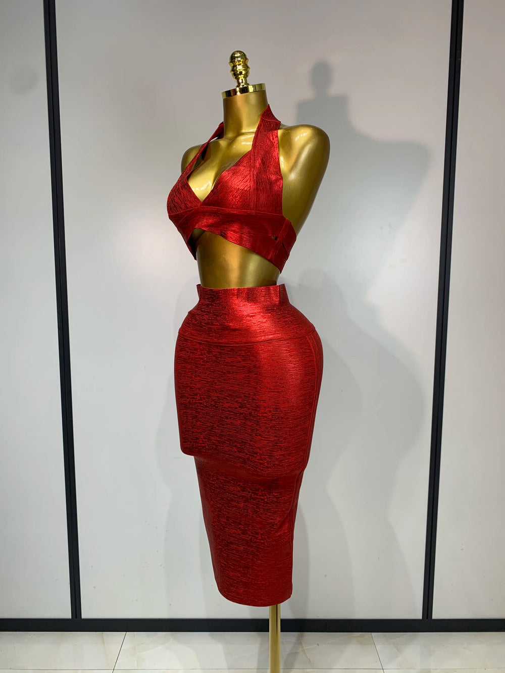 Metallic knit halter neck crop top and high-waisted midi skirt two-piece set, side view.