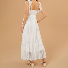 White lace dress on a beige background