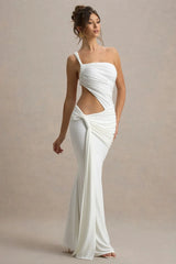 Woman wearing a white evening gown with a cutout design on a beige background