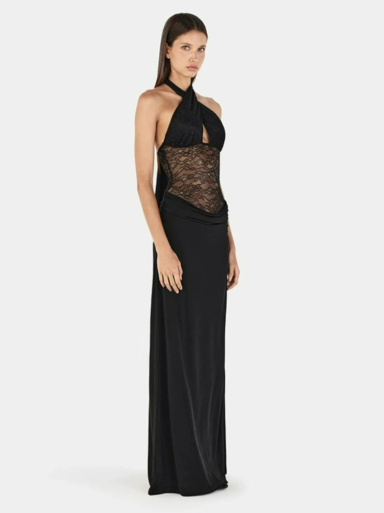 Side view of halter neck maxi dress with black lace bodice and black skirt