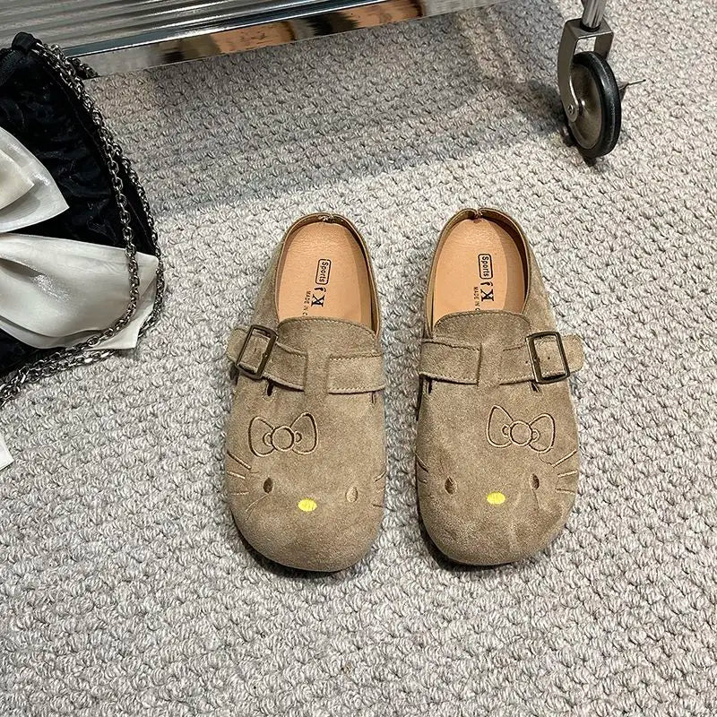 Taupe suede Hello Kitty buckle mules