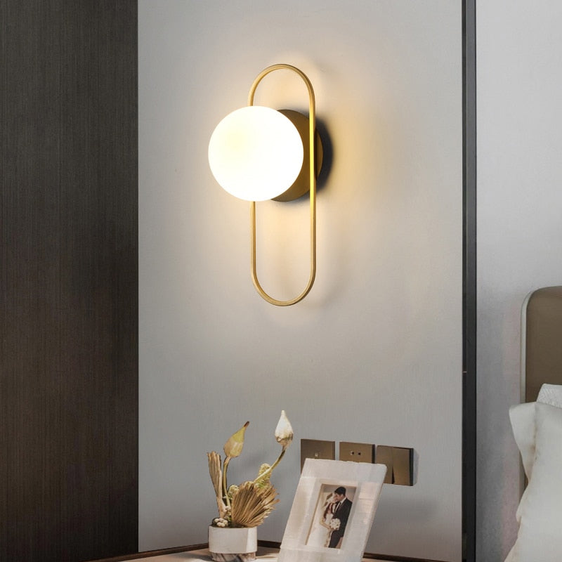 An LED 7W G9 Bulb Indoor Wall Sconce with a primary image showing a bronze -colored sconce in a modern style  over a family portrait.