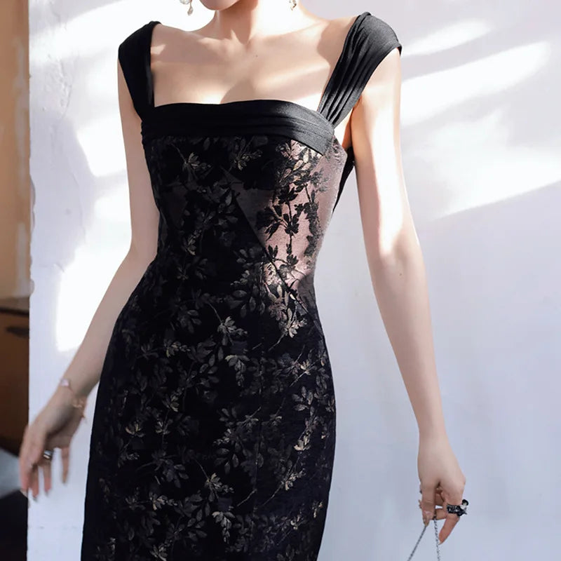 Black lace dress worn by a model against a white background
