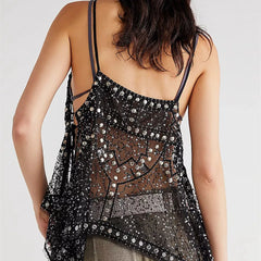 Black sequin top worn by a person on a white background