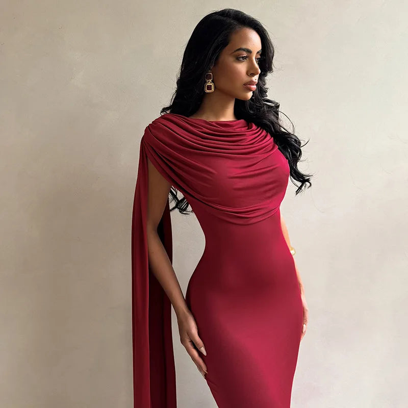 Woman wearing a red dress with a draped effect on a beige background