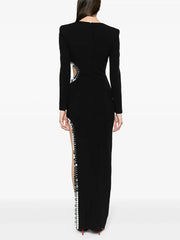 Back view of black long sleeve maxi dress with cutout detail