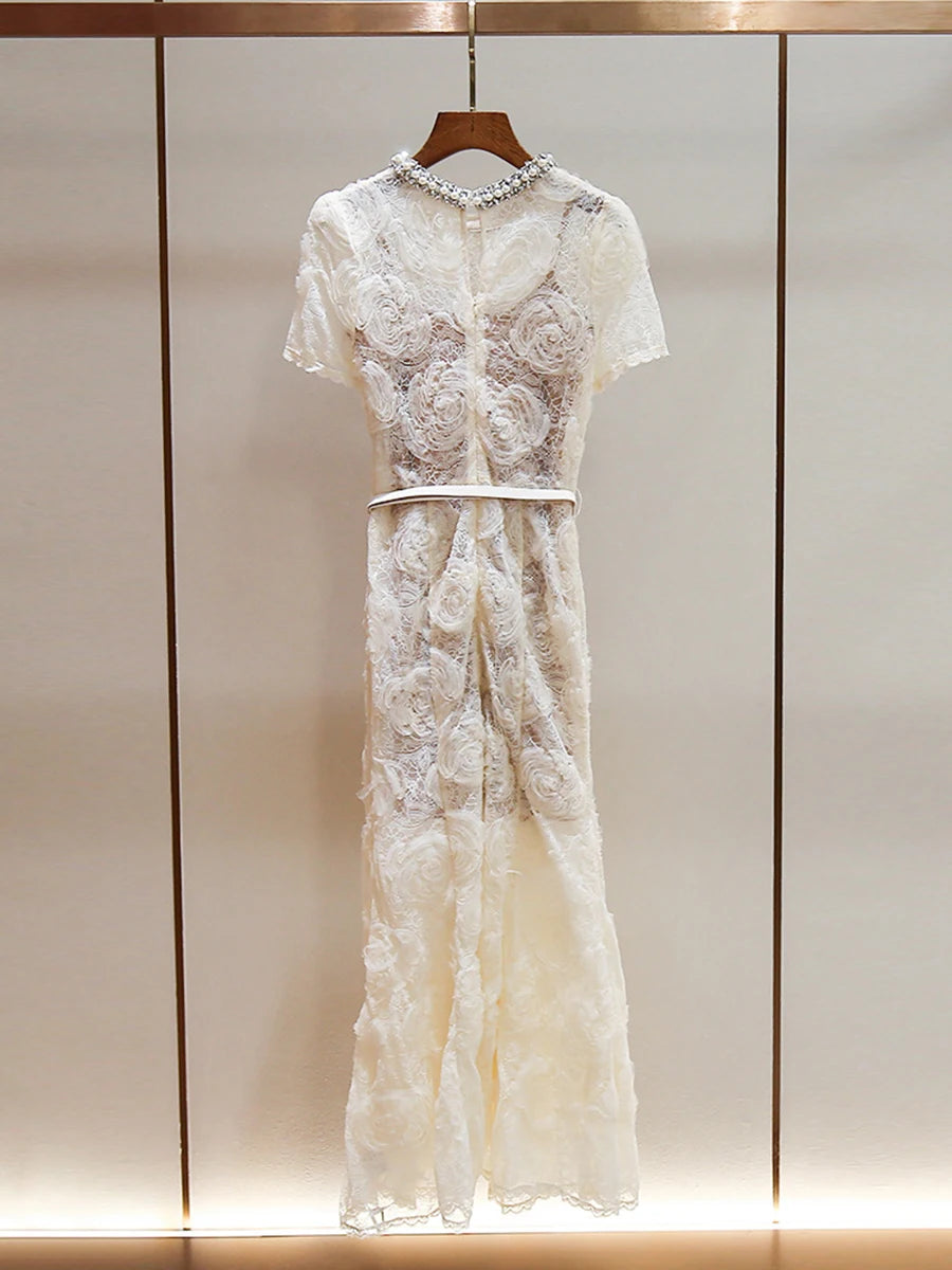 White lace dress on a hanger against a neutral background
