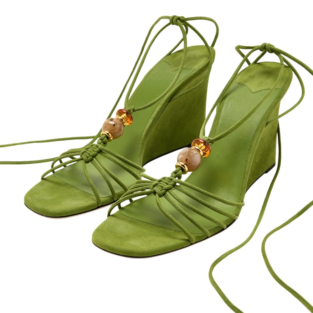 Green suede strappy wedge sandals with natural stone beads and ankle wrap tie