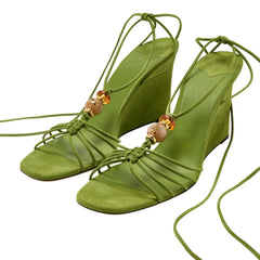Green suede strappy wedge sandals with natural stone beads and ankle wrap tie