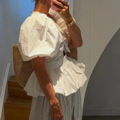 White puff sleeve top with bow detail and cutout, side view