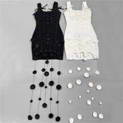 Black and white mini dresses with circular appliqués displayed side-by-side