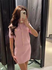 Person wearing a pink dress taking a mirror selfie.