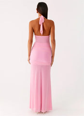 Pink halter neck gown with a tie detail on a white background