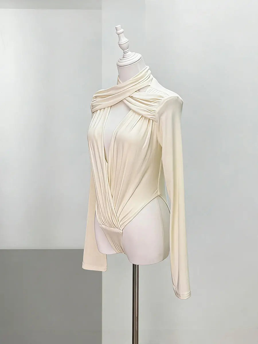 An apricot long-sleeve top on a mannequin against a plain background