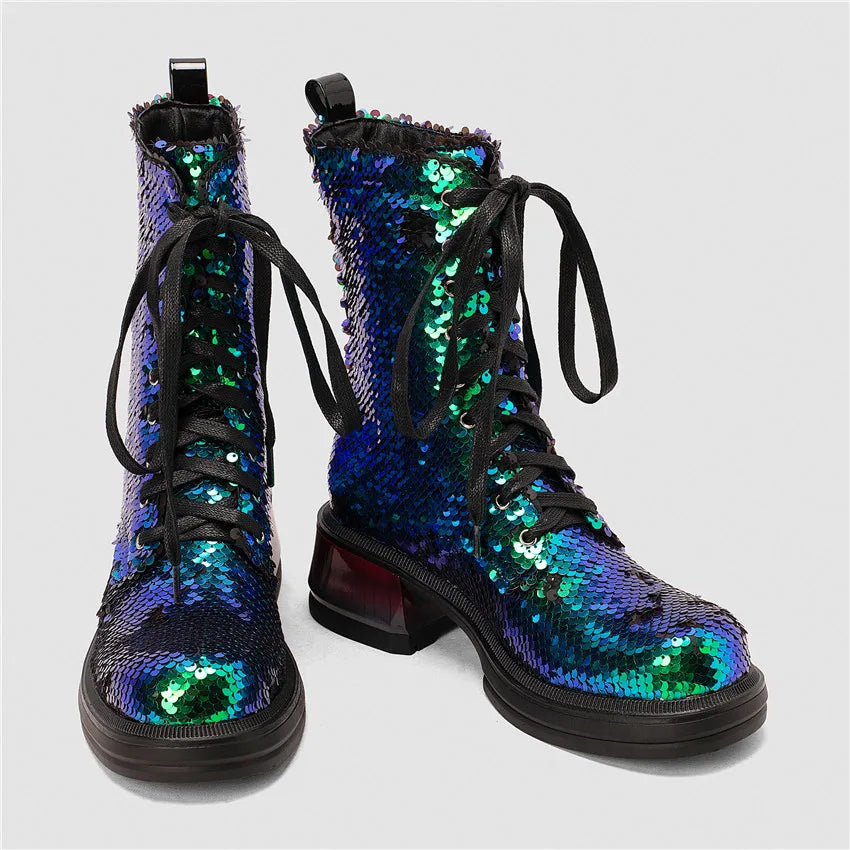 Pair of sequined boots with a colorful pattern on a light gray background