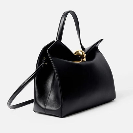 Black structured shoulder bag with a gold metal buckle