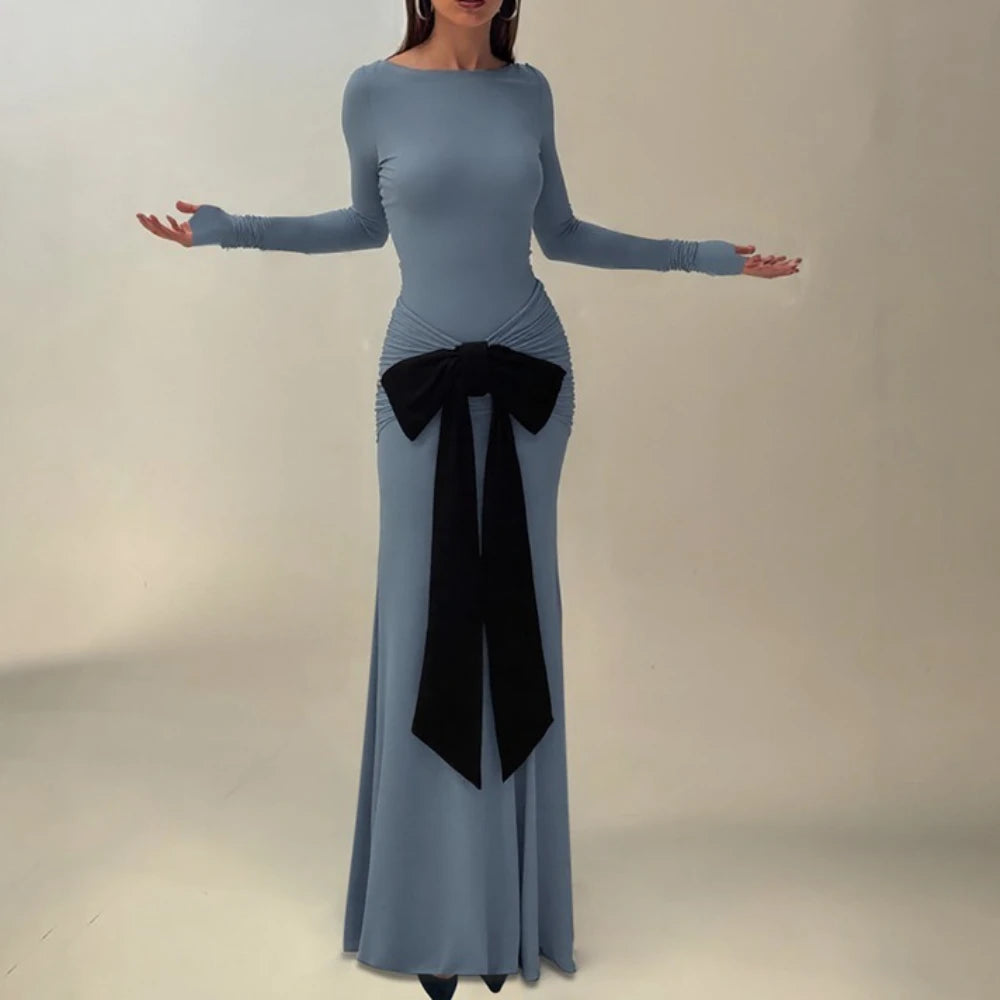 Blue dress with a black bow on a neutral background