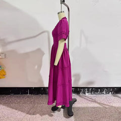 Purple dress on a mannequin against a plain background